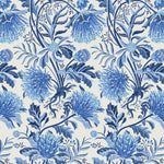 Detail of wallpaper in a dense floral print in shades of blue and navy on a white field.