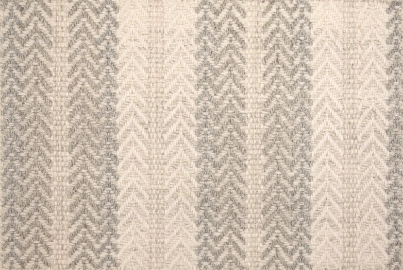 Broadloom carpet swatch in a herringbone pattern in a cream light grey design