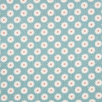 Detail of fabric in a repeating blossom print in white on a light turquoise field.