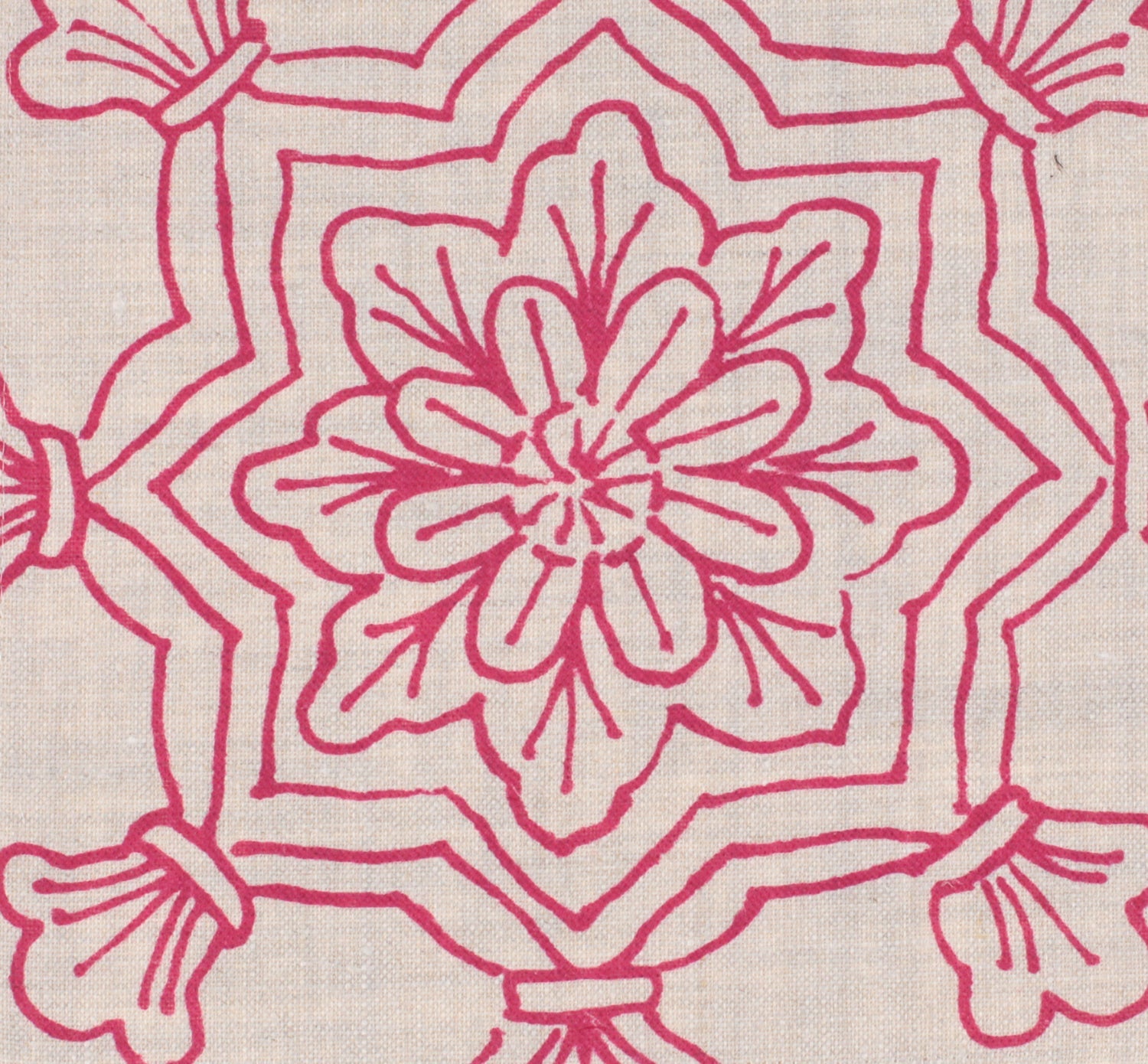 Detail of fabric in a floral medallion print in pink on a cream field.