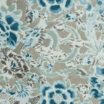 Detail of a linen fabric in a painterly floral pattern in shades of blue and brown on a greige field.