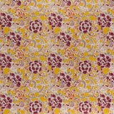 printed linen fabric in a painterly floral pattern in shades of white, orange and purple on a mustard field.