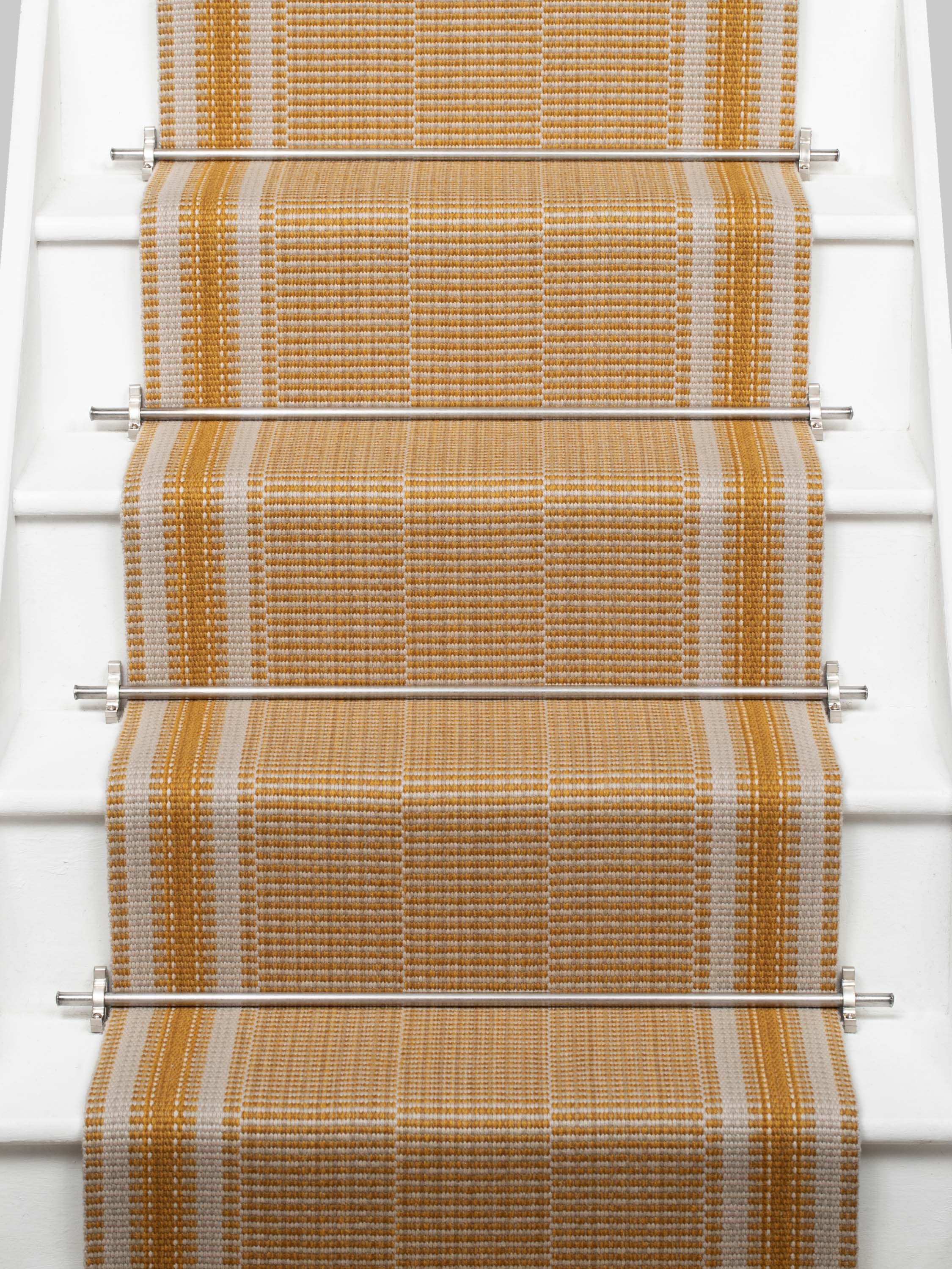 Striped flatweave runner in orange on white staircase 