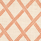 Detail of fabric in a diamond lattice print in orange on a cream field.