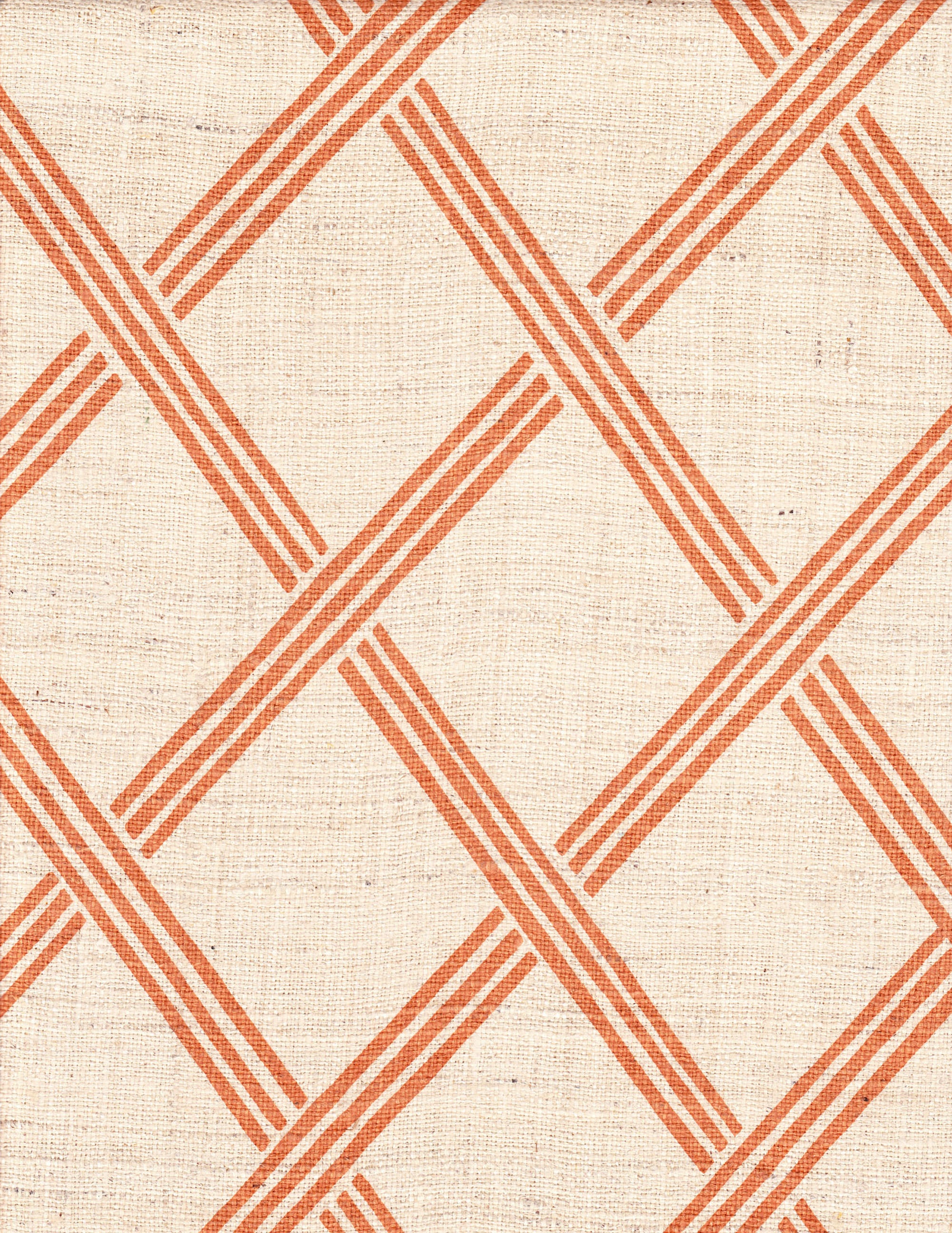 Detail of fabric in a diamond lattice print in orange on a cream field.