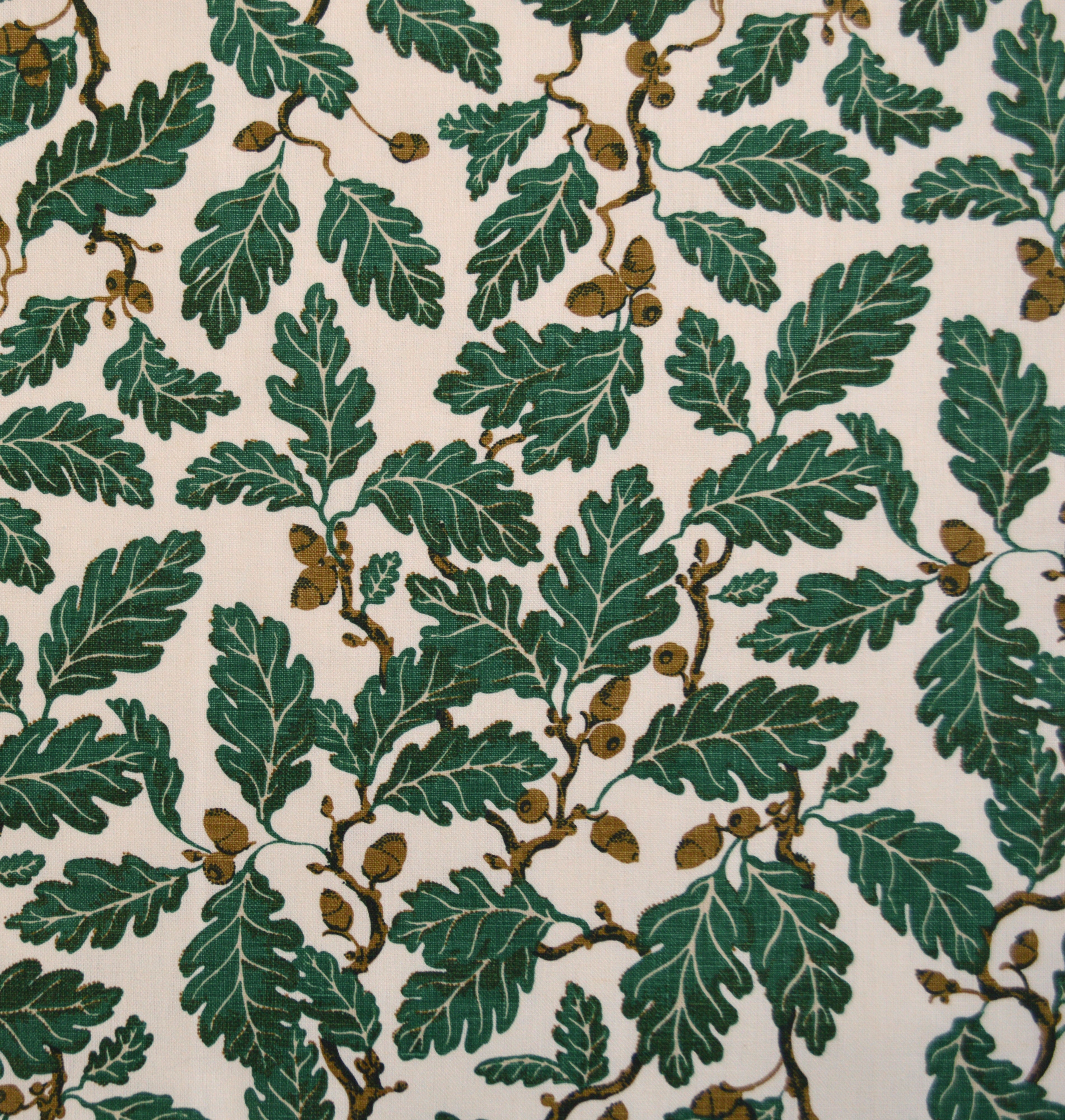 Pattern of green leaves and acorns on a beige background
