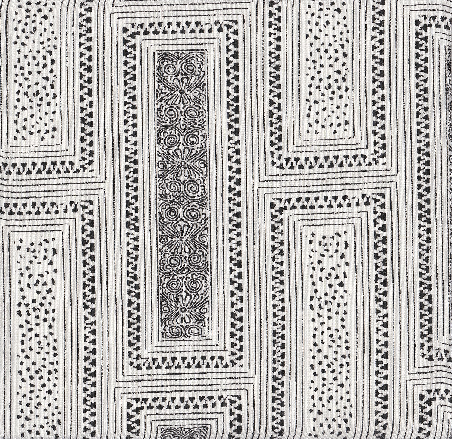 Detail of fabric in a complex interlocking geometric print in black on a white field.