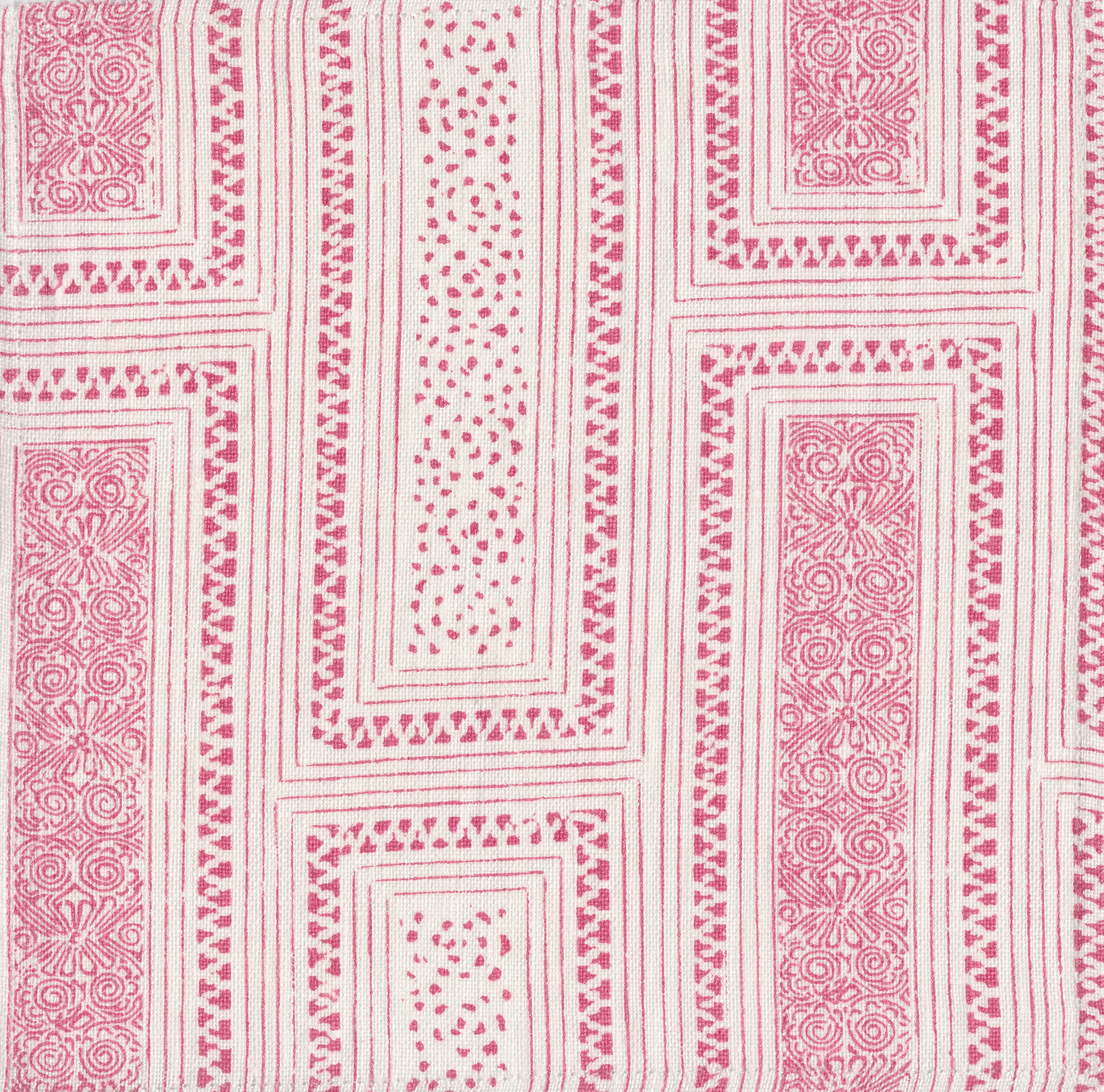 Detail of fabric in a complex interlocking geometric print in pink on a cream field.