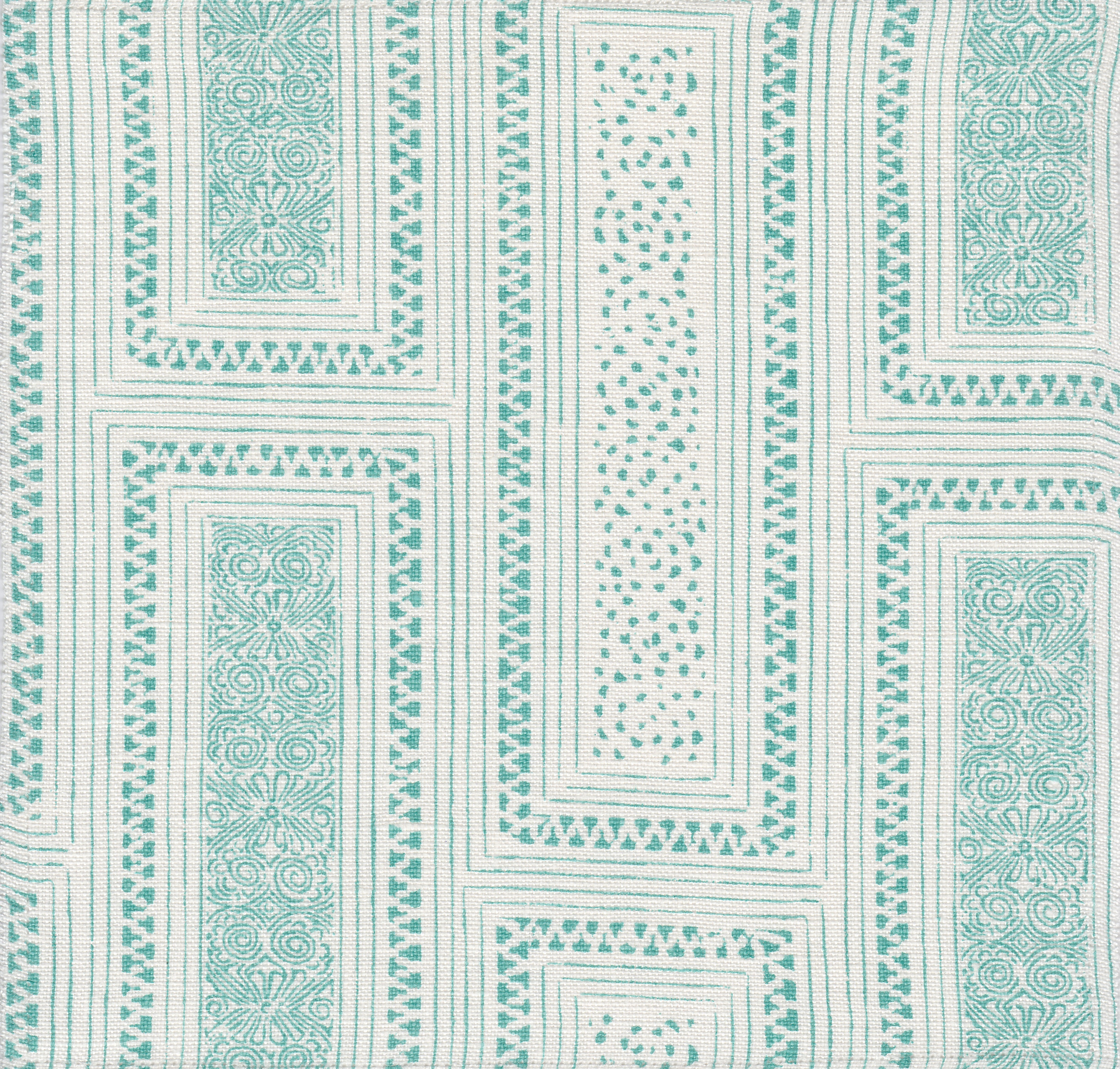 Detail of fabric in a complex interlocking geometric print in turquoise on a cream field.