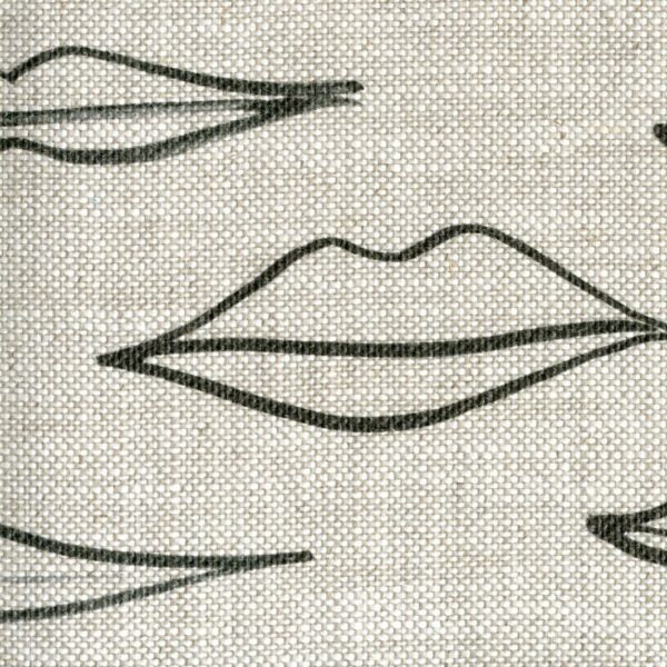 Fabric in a painterly lip pattern in black on a cream field.