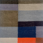 Detail of a flatwoven rug in a graphic broken stripe pattern in bright colors- orange, blue, grey, black and brown. 