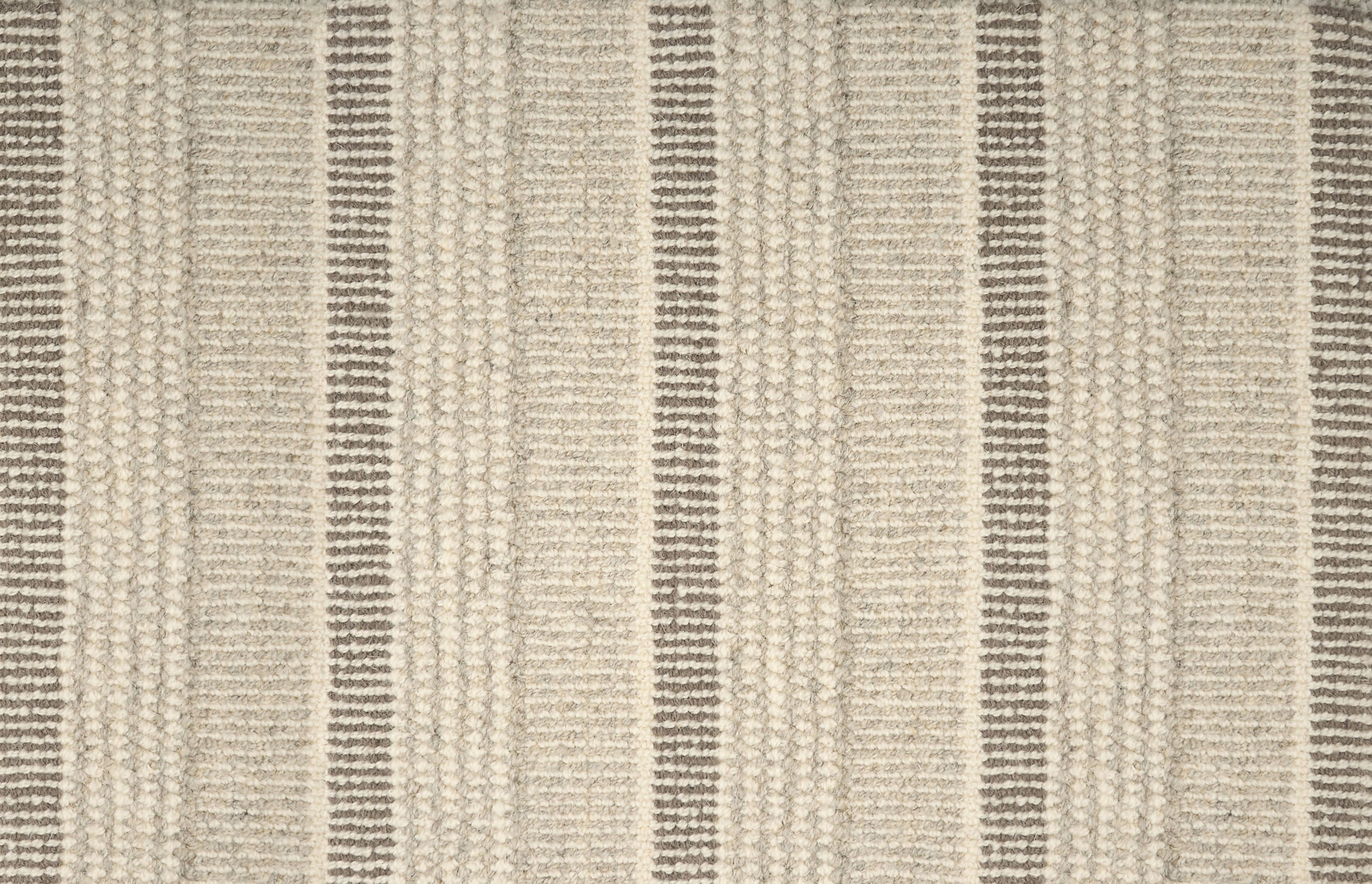 Textured broadloom carpet in ecru with stripes in grey.