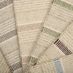 A spread of striped broadloom samples in various colors. 