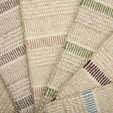 A spread of striped broadloom samples in various colors. 