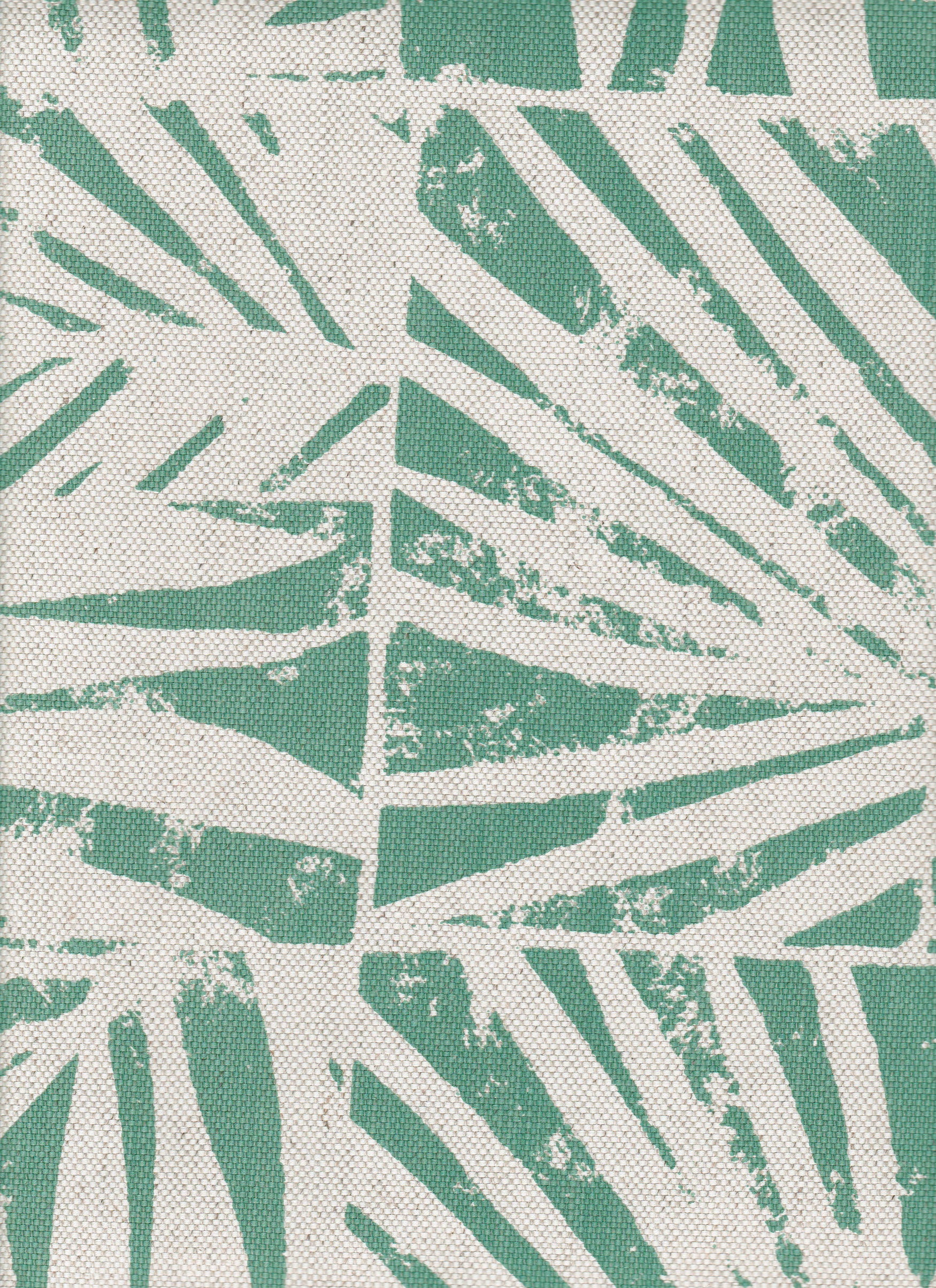 Detail of fabric in a botanical grid print in turquoise on a white field.