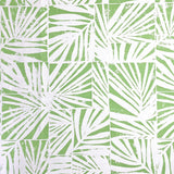 Detail of fabric in a botanical grid print in green on a white field.