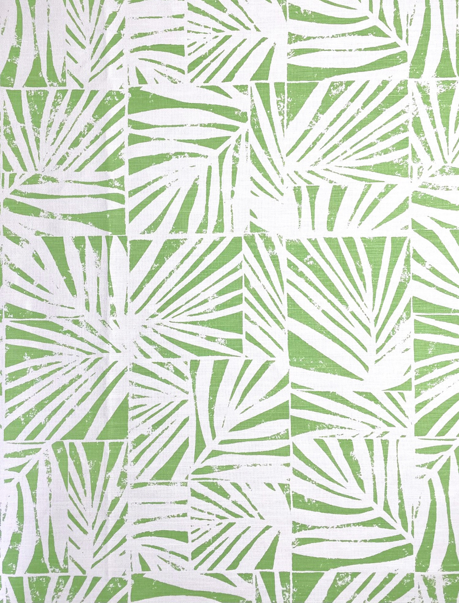 Detail of fabric in a botanical grid print in green on a white field.