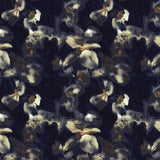 Detail of fabric in an abstract floral print in tan, gold and navy on a black field.