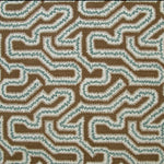 Detail of fabric in a dense meandering print in white, blue and gray on a brown field.