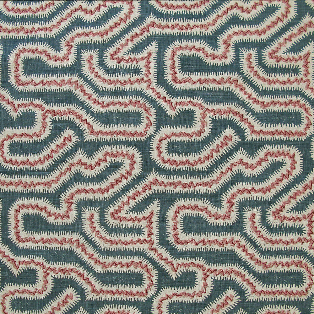 Detail of fabric in a dense meandering print in white, pink and red on a navy field.