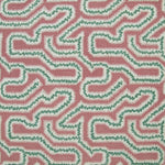 Detail of fabric in a dense meandering print in white and green on a pink field.