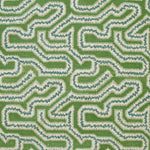 Detail of fabric in a dense meandering print in white, blue and navy on a green field.