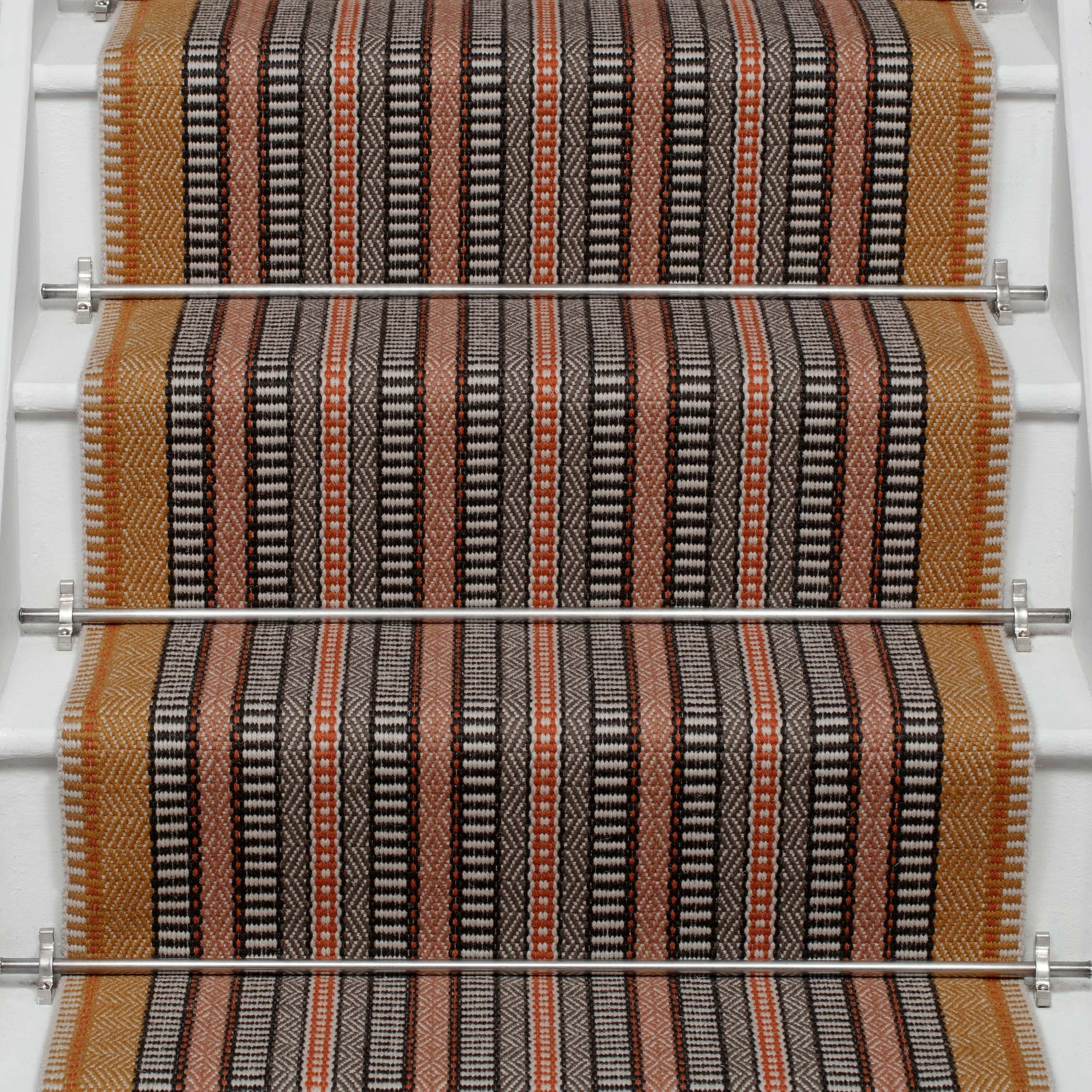 Striped flatweave runner in orange black red on white staircase