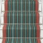 Striped flatweave runner in red blue and green black on white staircase