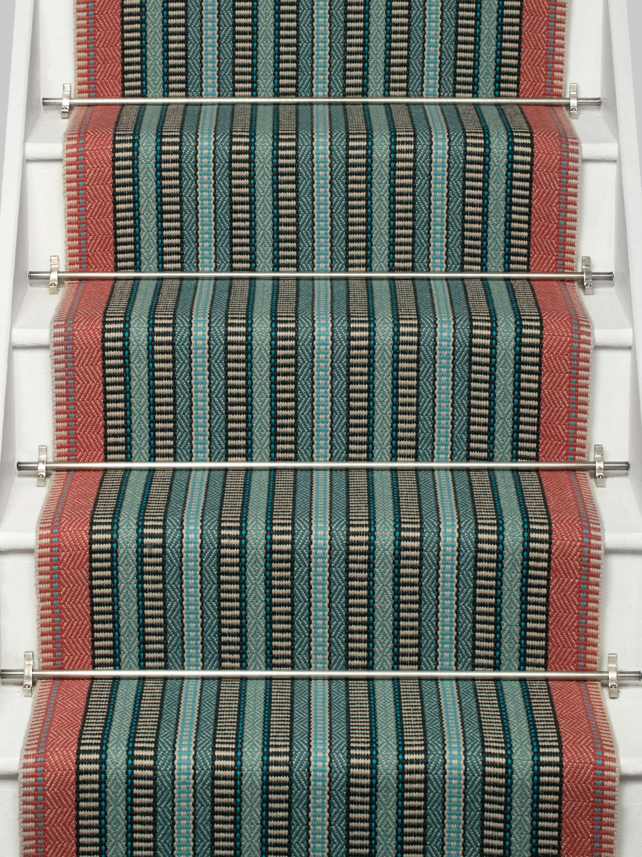 Striped flatweave runner in red blue and green black on white staircase