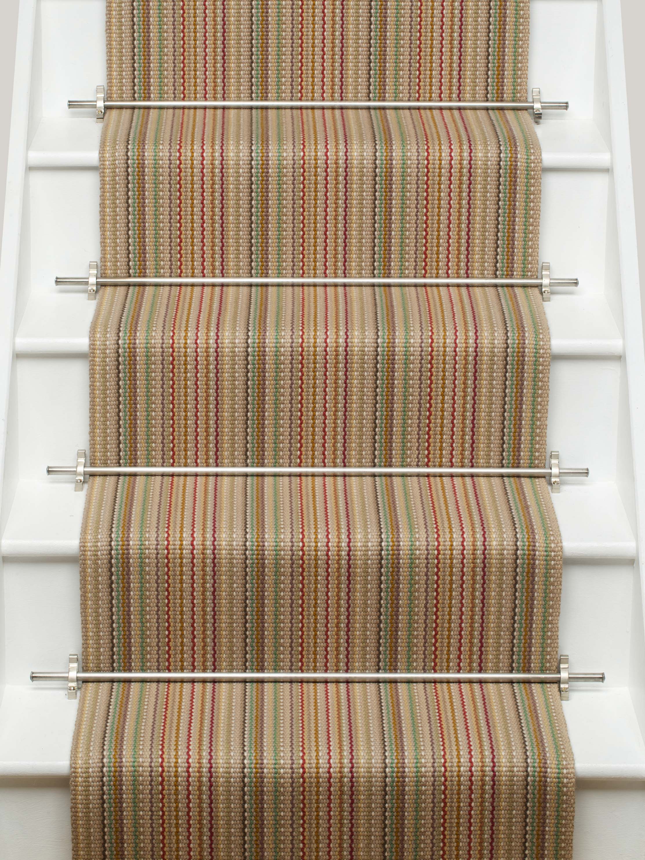 Striped flatweave runner in tan pink green blue on white staircase