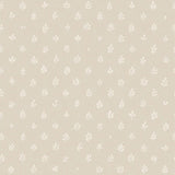 Detail of wallpaper in a repeating leaf print in white on a cream field.