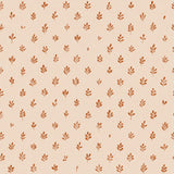 Detail of wallpaper in a repeating leaf print in burnt orange on a cream field.