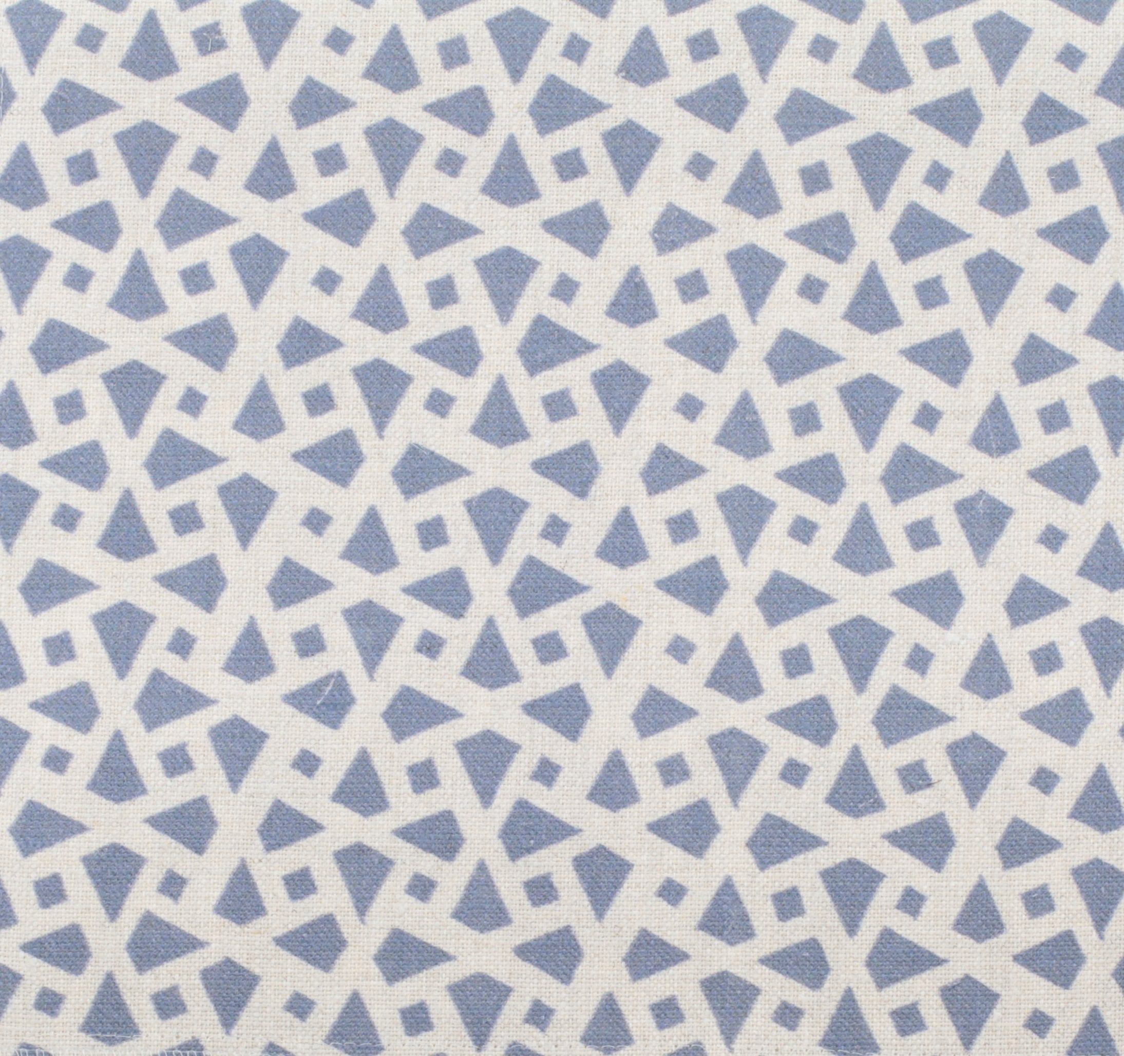 Detail of fabric in a geometric lattice print in blue on a cream field.