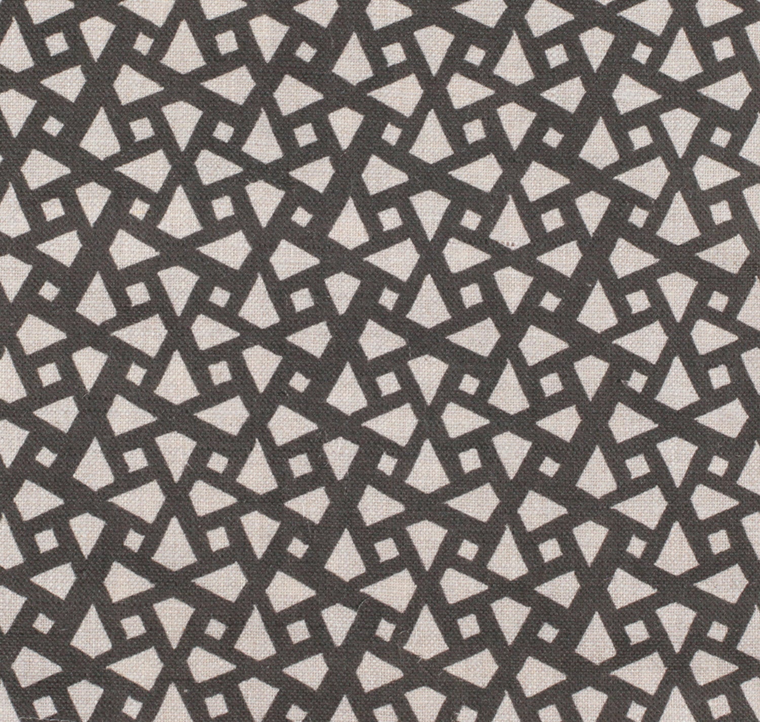 Detail of fabric in a geometric lattice print in charcoal on a greige field.