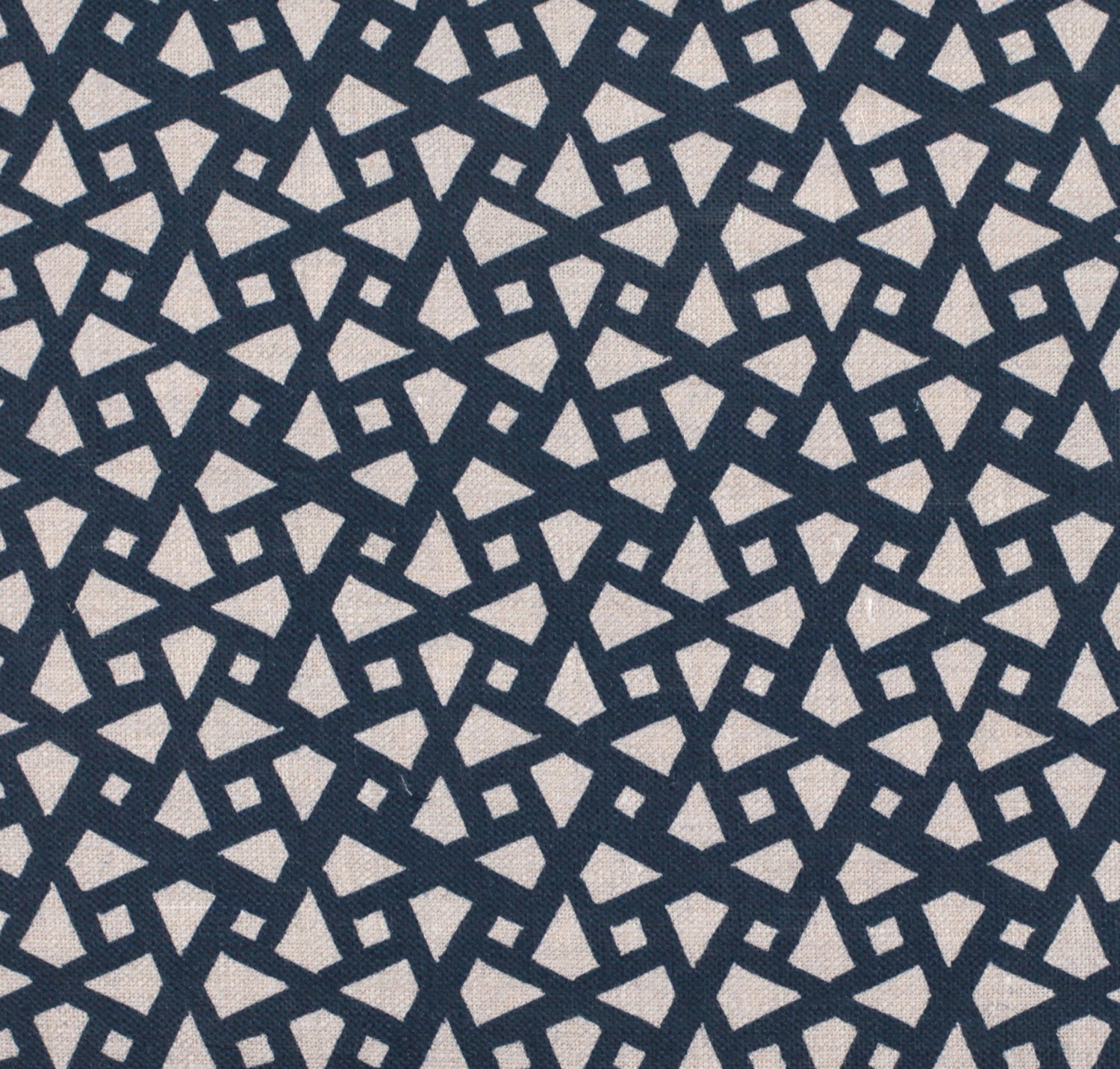 Detail of fabric in a geometric lattice print in navy on a cream field.