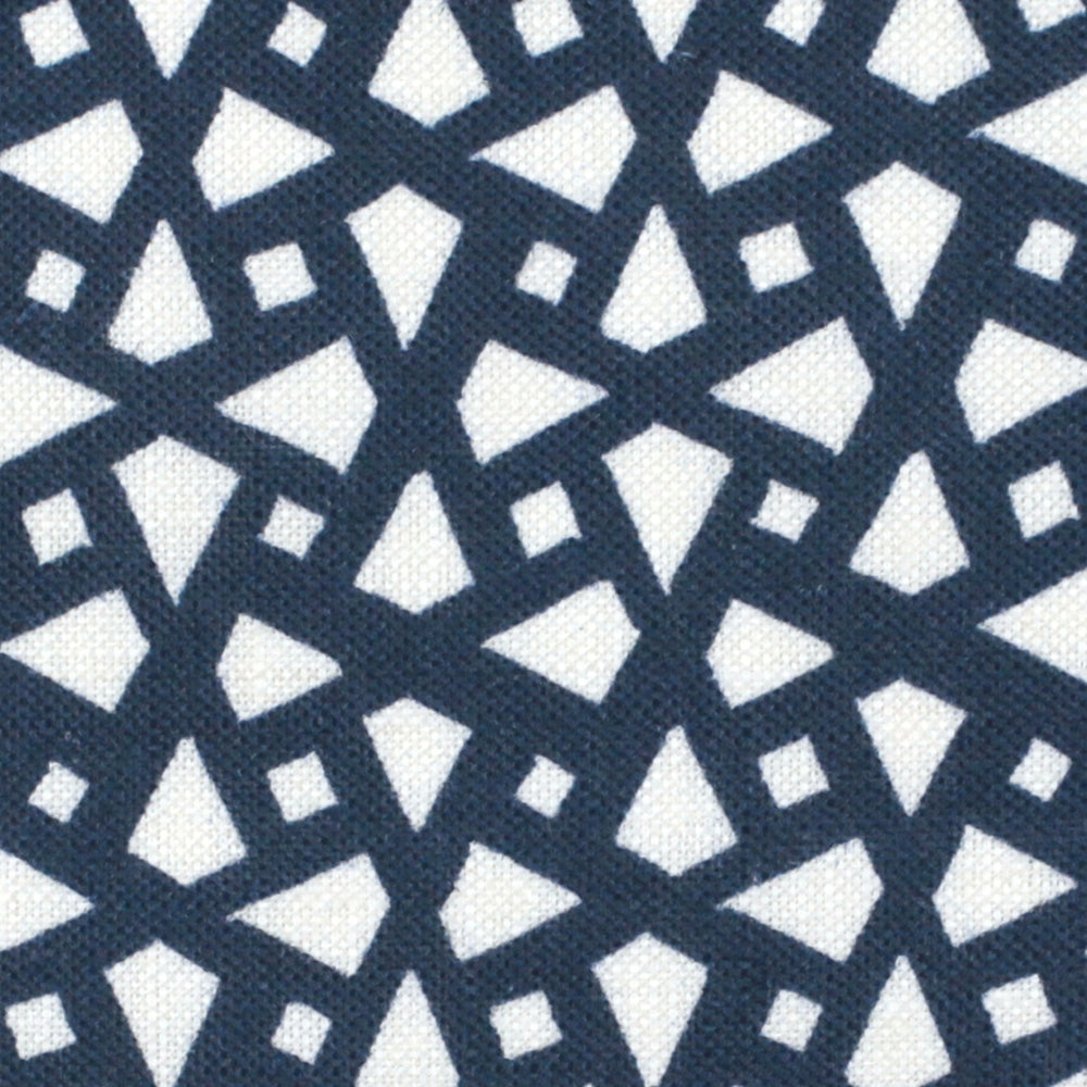 Detail of fabric in a geometric lattice print in navy on a white field.