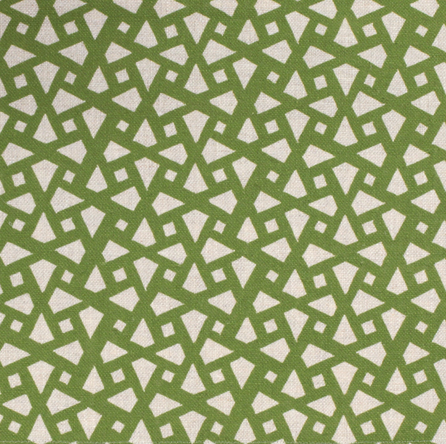 Detail of fabric in a geometric lattice print in green on a greige field.