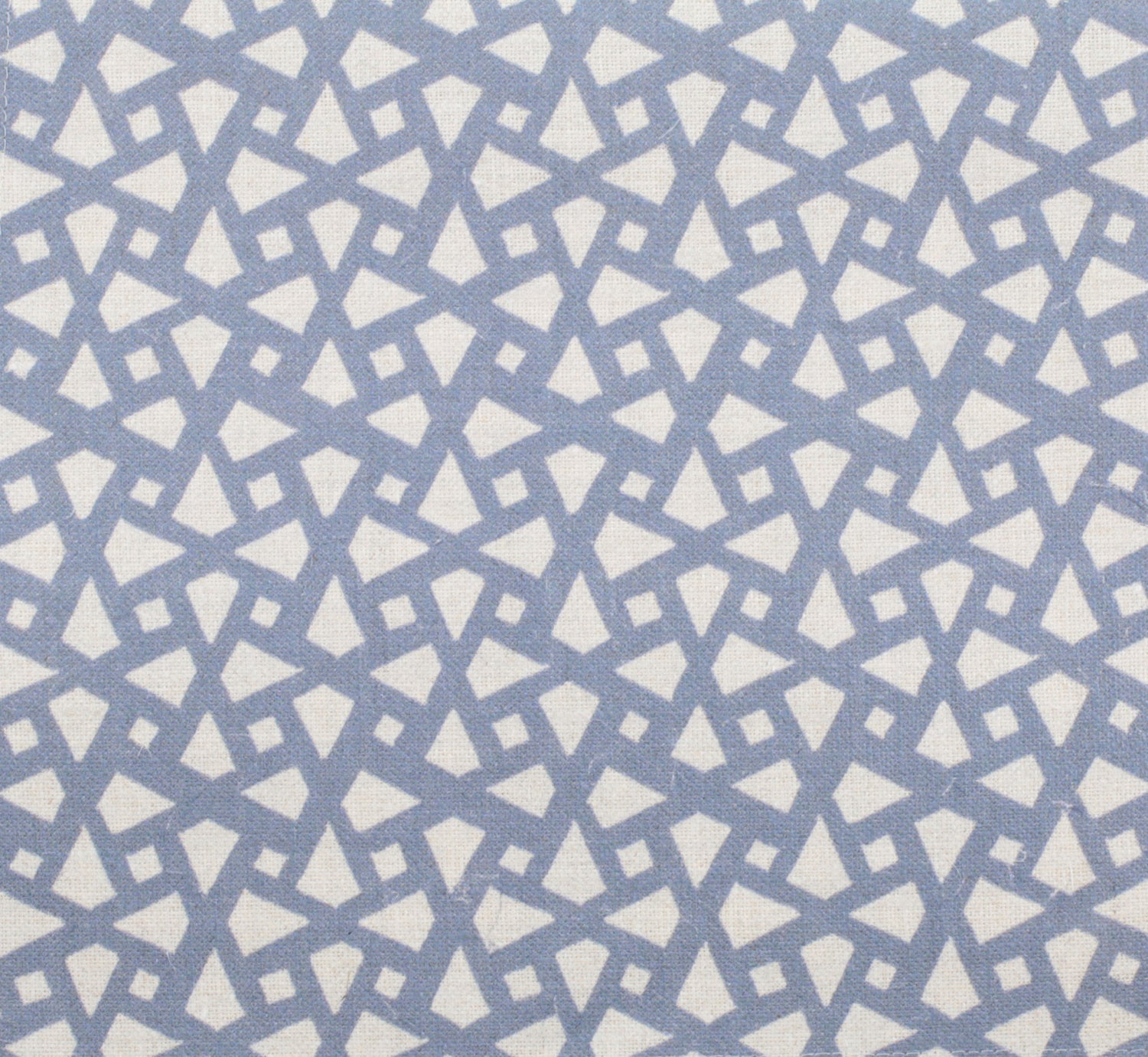 Detail of fabric in a geometric lattice print in blue on a cream field.