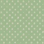 Detail of fabric in a repeating leaf print in cream on a green field.