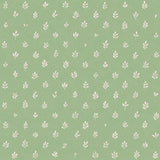 Detail of fabric in a repeating leaf print in cream on a green field.