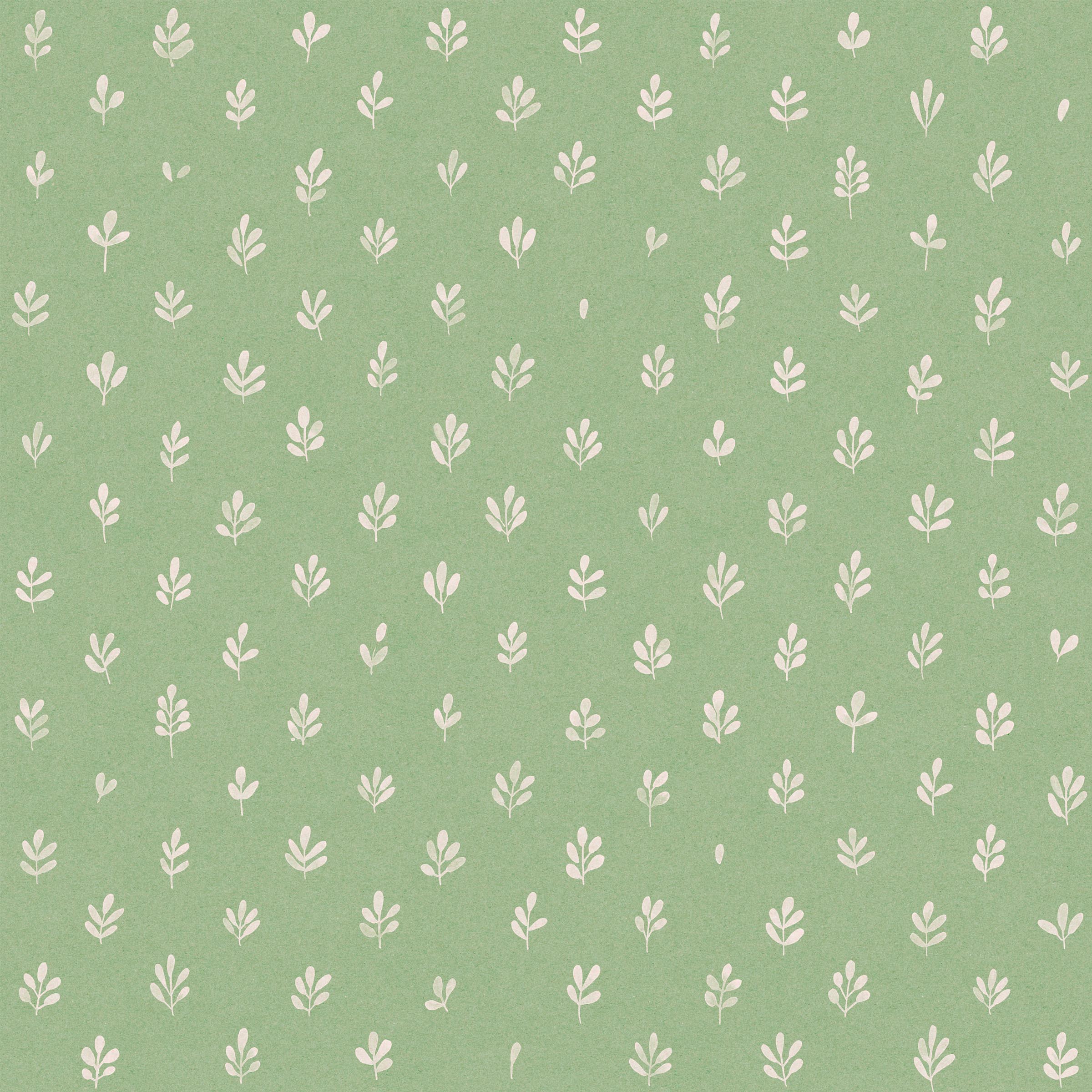 Detail of fabric in a repeating leaf print in cream on a green field.