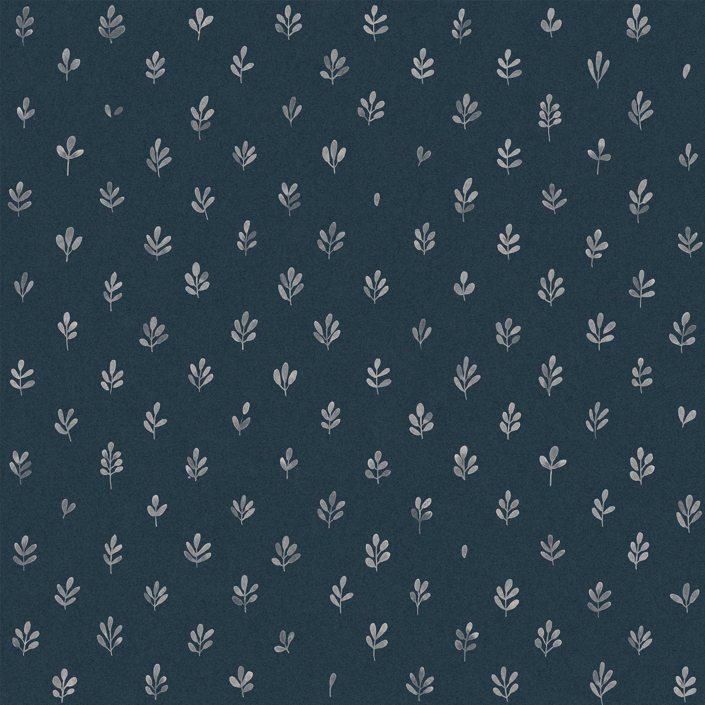 Detail of fabric in a repeating leaf print in cream on a navy field.
