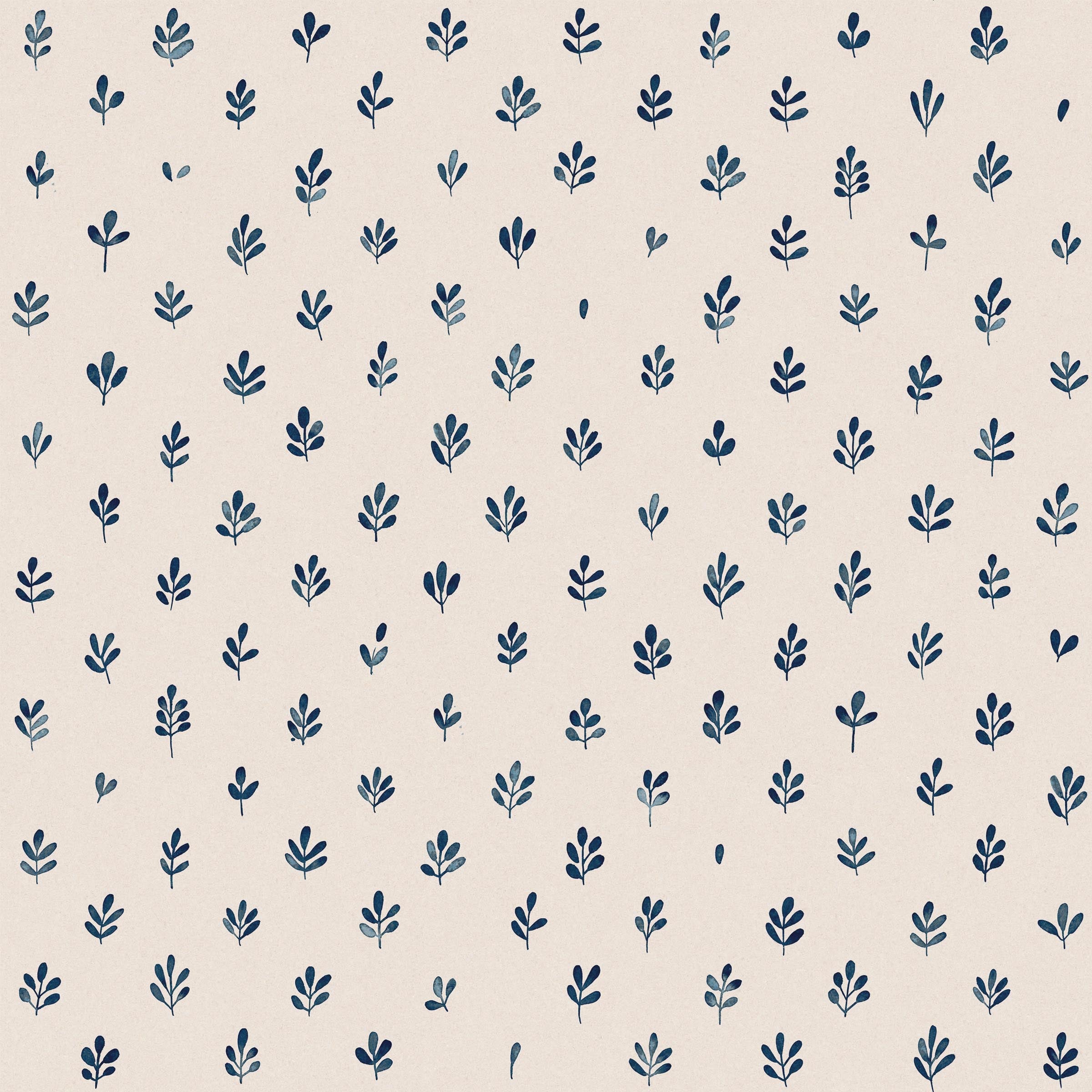 Detail of fabric in a repeating leaf print in navy on a cream field.