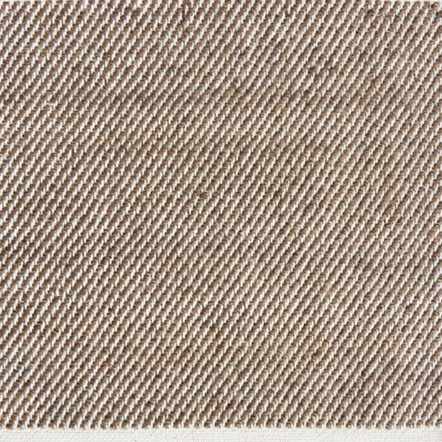 Detail of a flatwoven rug, with a brown and white twill design