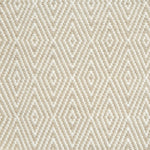 Flatwoven rug detail with a cream and taupe diamond pattern.