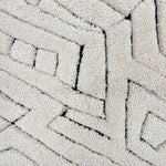 Handknotted Moroccan style rug with a geometric ivory pattern.