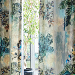 A large potted tree stands behind long curtains in a painterly botanical print.