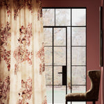 A modernist living space with large windows and curtains in a painterly botanical print.