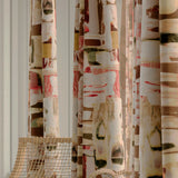 Close-up of a row of curtains in an abstract layered paint blotch print in shades of olive, cream and pink.