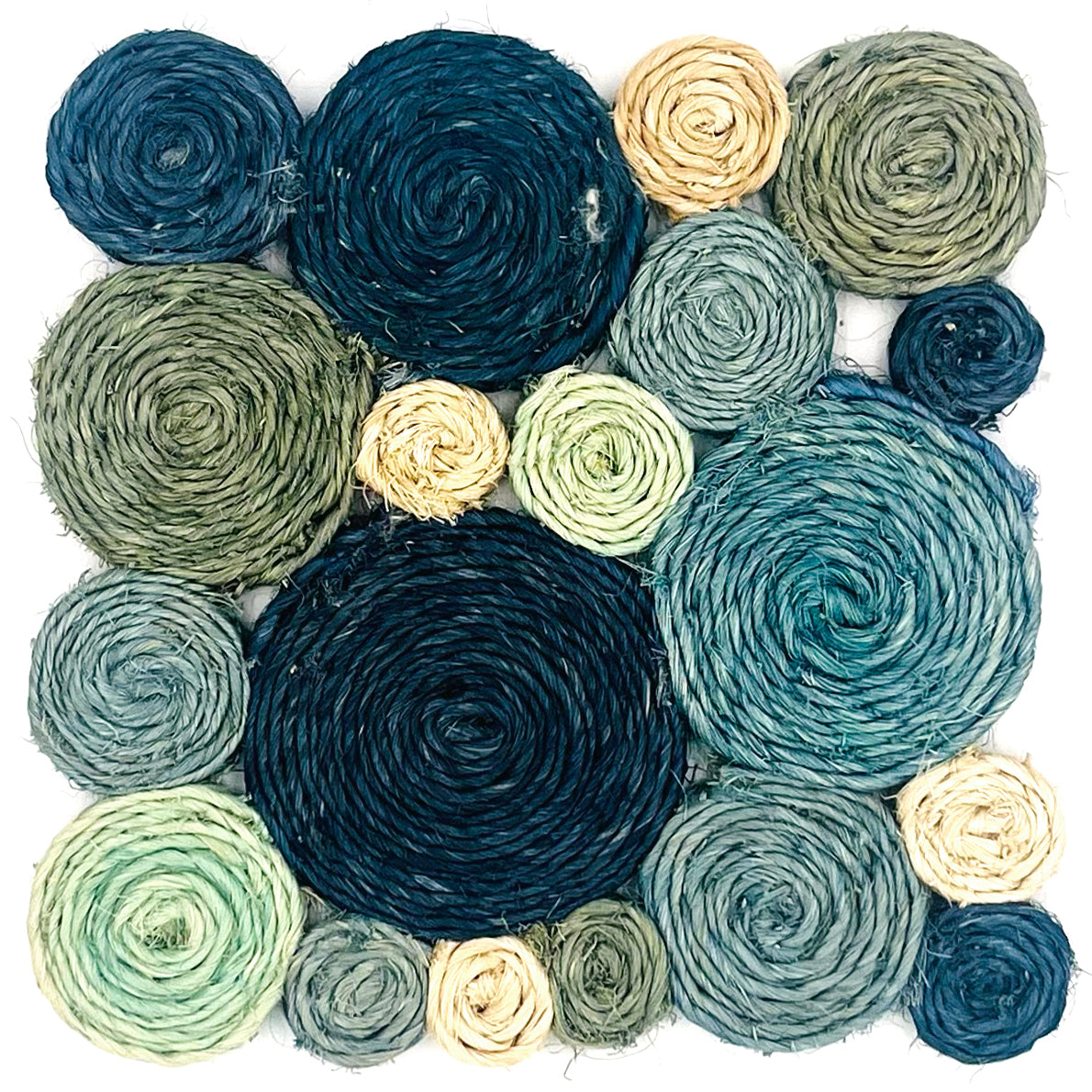 A woven rug swatch in natural fibers made up of circles in an organic pattern in shades of blue, acqua, turqoise and white.